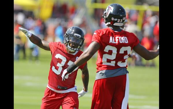 073115 FLOWERY BRANCH: Falcons safety Ricardo Allen (left) and cornerback Robert Alford celebrate a defensive take away during the first day of training camp on Friday, July 31, 2015, in Flowery Branch. Curtis Compton / ccompton@ajc.com