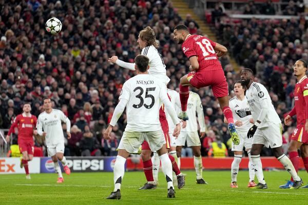 Liverpool's Cody Gakpo, center, scores his side's second goal during the Champions League opening phase soccer match between Liverpool and Real Madrid at Anfield Stadium, Liverpool, England, Wednesday, Nov. 27, 2024. (AP Photo/Jon Super)