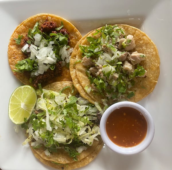 Birrieria Landeros offers street tacos, including (clockwise, from top left) chorizo, lechon (pork), and asada (steak). (Ligaya Figueras / ligaya.figueras@ajc.com)