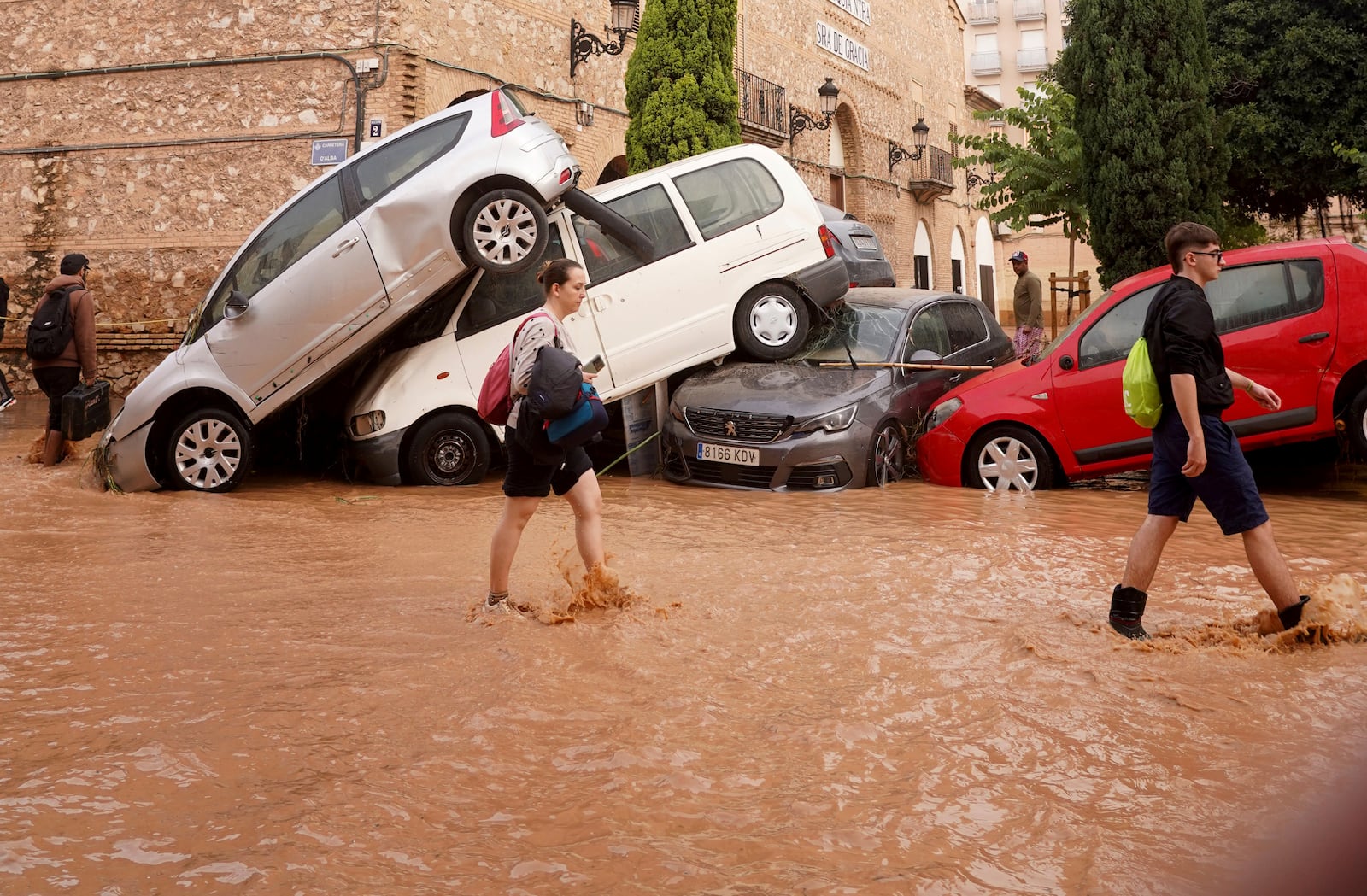 Residents walk through flooded streets in Valencia, Spain, Wednesday, Oct. 30, 2024. (AP Photo/Alberto Saiz)