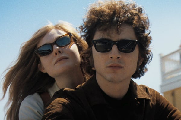 Elle Fanning (left) as Sylvie Russo and Timothée Chalamet as Bob Dylan take a motorcycle ride to the 1965 Newport Folk Festival, a fictitious scene in "A Complete Unknown." Courtesy of Searchlight Pictures/TNS