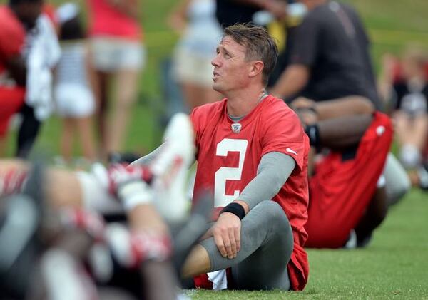 Falcons QB Matt Ryan knows how to tackle. Here he is as he stretches during the minicamp. Atlanta Falcons players workout during the second day of mini-camp at the team's facilities in Flowery Branch, Wednesday, June 18, 2014. KENT D. JOHNSON/KDJOHNSON@AJC.COM