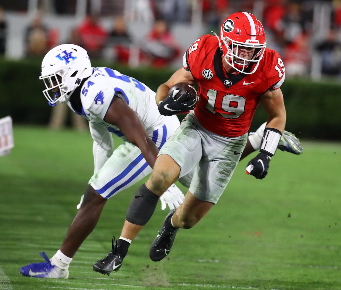 Georgia tight end Brock Bowers makes a first down gain past Kentucky linebacker D'Eryk Jackson during the third quarter in a NCAA college football game on Saturday, Oct. 7, 2023, in Athens.  Curtis Compton for the Atlanta Journal Constitution