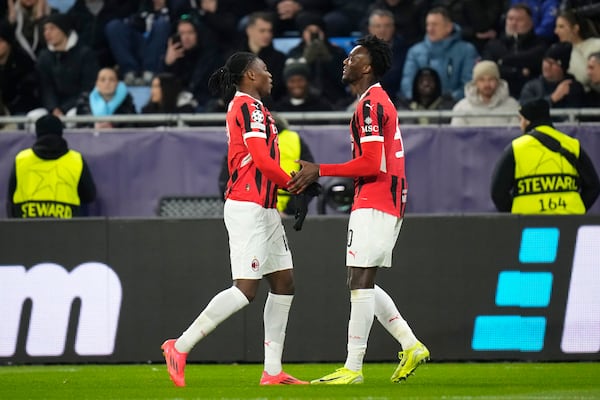 Tammy Abraham of AC Milan (right) celebrates the third goal against Slovan Bratislava during the Champions League opening match between Slovan Bratislava and AC Milan in Bratislava, Slovakia on Tuesday, November 26, 2024. (AP Photo/Petr David Josek)