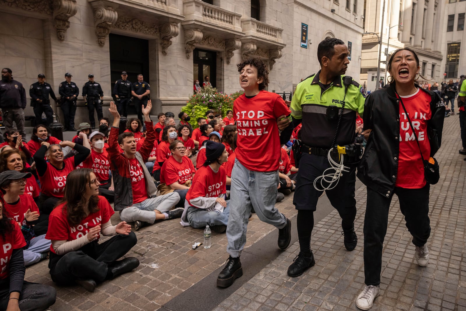 Police officers detain demonstrators protesting Israel's war against Hamas as they occupy an area outside the New York Stock Exchange, Monday, Oct. 14, 2024, in New York. (AP Photo/Yuki Iwamura)