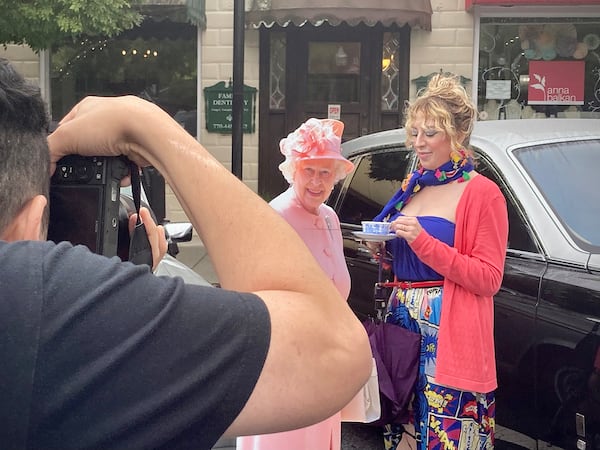 Ella Beth Villaroto couldn't pass up a chance to get her photo taken with a likeness of her majesty at the Atlanta British Car Fayre. Her husband, Tony, obliged. (Mark Davis / For The Atlanta Journal-Constitution)