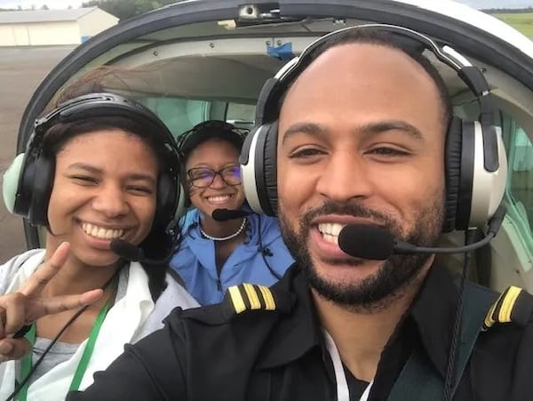 Atlanta pilot and flight instructor Omar Brock (right) is pictured in the cockpit of a plane with participants in the Brock Foundation’s annual “Gift of Flight” event in June 2022 in Anniston, Alabama. (Photo Courtesy of Omar Brock)