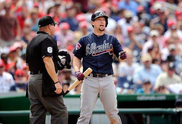 Atlanta Braves' Chris Johnson, right, gestures towards first after he struck out during the inning of a baseball game against the Washington Nationals, Sunday, June 22, 2014, in Washington. Johnson was ejected from the game. Also seen is home plate umpire Mark Carlson, left. The Nationals won 4-1. (AP Photo/Nick Wass) Chris Johnson is shocked at striking out. Like he never strikes out. (Nick Wass/AP)