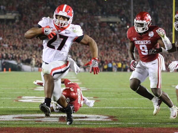 January 1, 2018 Pasadena: Georgia tailback Nick Chubb scores a touchdown to tie the game 45-45 during the fourth quarter to send it to over time in the College Football Playoff Semifinal at the Rose Bowl Game on Monday, January 1, 2018, in Pasadena. Georgia went on to beat Oklahoma 54-48 in double over time.   Curtis Compton/ccompton@ajc.com