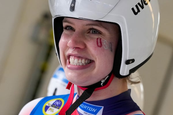 Chevonne Chelsea Forgan of the United States smiles after the women's sprint race at the Luge World Cup in Igls near Innsbruck, Austria, Saturday, Dec. 7, 2024. (AP Photo/Matthias Schrader)