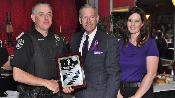 Bossier City police Officer Terry Yetman, far left, is pictured Oct. 5, 2018, with Caddo/Bossier Domestic Violence Task Force President Jim Taliaferro and Sgt. Tifani Brinkman of the Bossier City Police Department. Yetman, who was honored that day for his work with domestic violence victims and their families, was arrested Wednesday, Dec. 19, 2018, on 40 counts of animal sexual abuse.