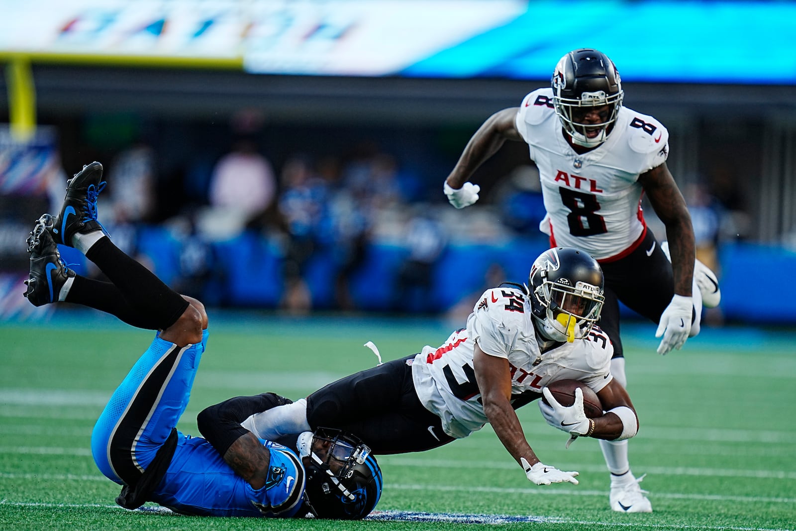 Atlanta Falcons wide receiver Ray-Ray McCloud III (34) is tackled by Carolina Panthers cornerback Jaycee Horn (8) in the first half of an NFL football game in Charlotte, N.C., Sunday, Oct. 13, 2024. (AP Photo/Rusty Jones)