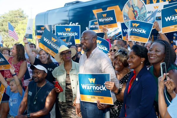 083122 Marietta, Ga.: Democratic U.S. Senatorial incumbent Raphael Warnock, center, gets a group photograph taken with supporters during a campaign stop at the Cobb County Civic Center on Wednesday, August 31, 2022, in Marietta, Ga.. (Jason Getz / Jason.Getz@ajc.com)