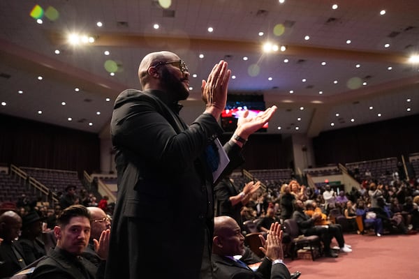 Tyler Perry stands and applauds at the memorial service for singer and actress Angie Stone, Friday, March 14, 2025, in Austell. Ga. (AP Photo/Olivia Bowdoin)