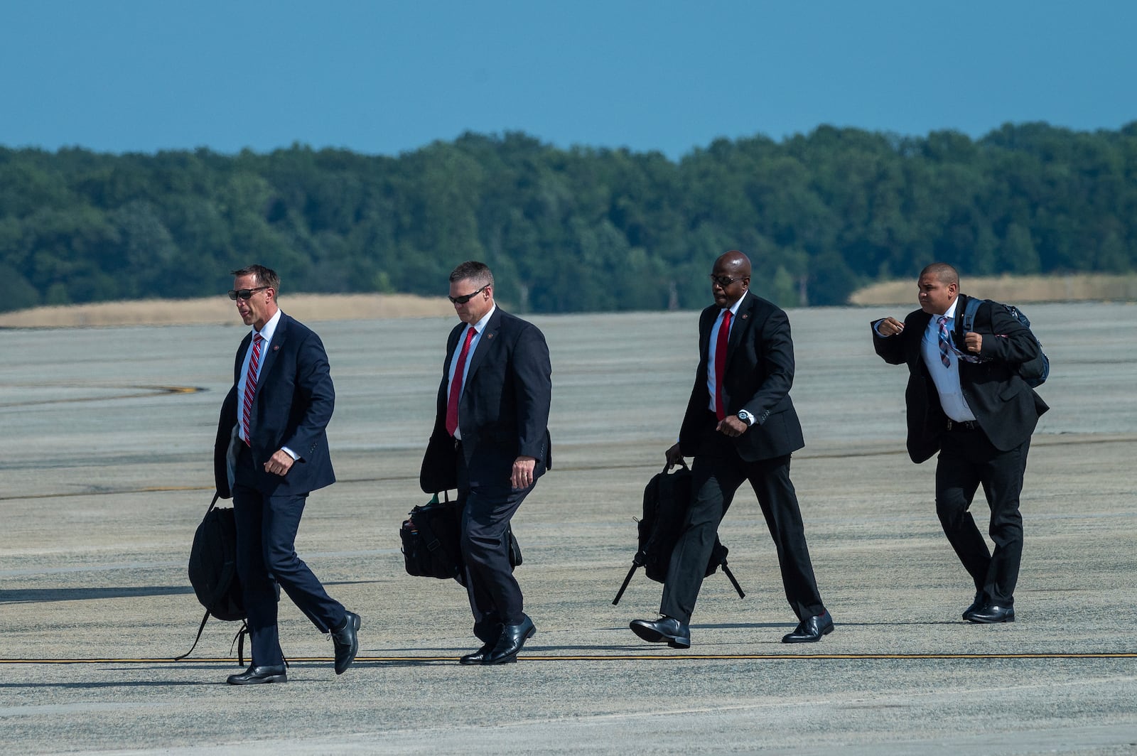 FILE - Members of President Joe Biden's Secret Service detail walk to Air Force One at Andrews Air Force Base, Md., Monday, July 15, 2024. (AP Photo/Cliff Owen, File)