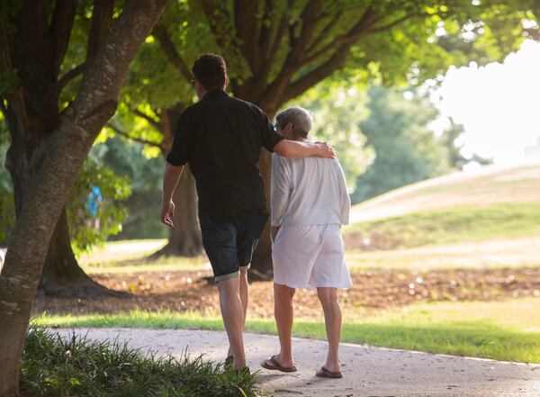 Maureen Kalmanson and Chip Powell, former bosses of the late Katherine Janness, walk together after a memorial for Janness on Thursday, July 28, 2022, at Piedmont Park in Atlanta, Georgia. The memorial marks the one-year anniversary of the murder of Janness and her dog, Bowie. CHRISTINA MATACOTTA FOR THE ATLANTA JOURNAL-CONSTITUTION.