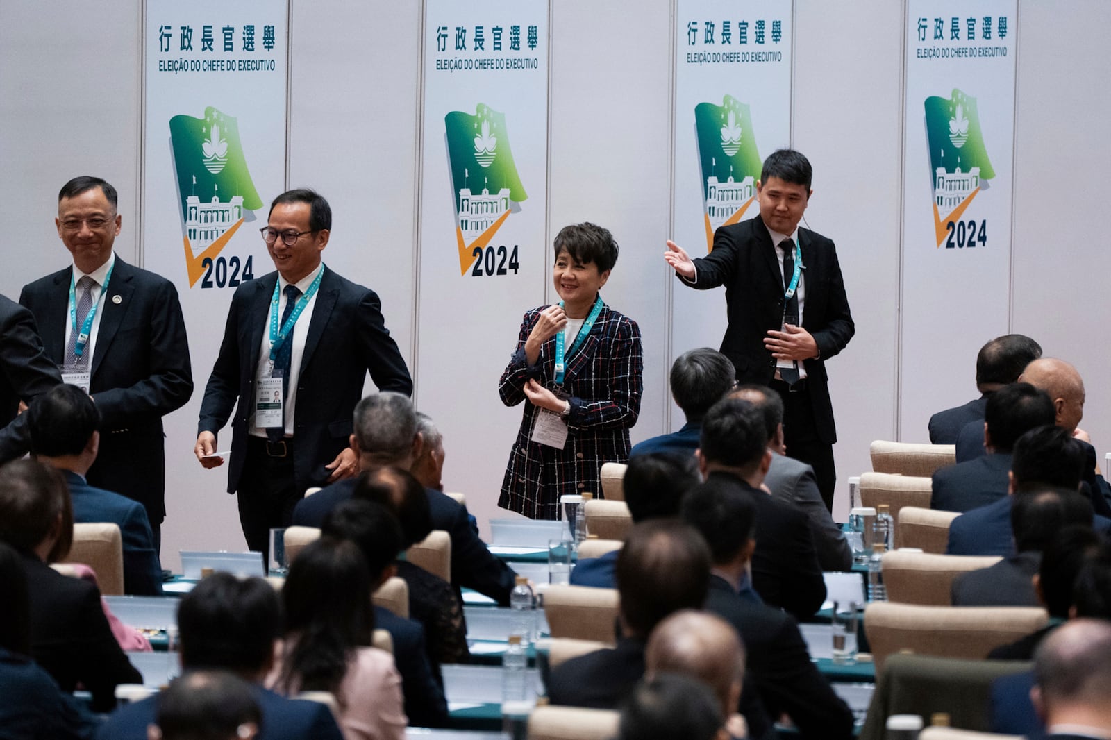 Lawmaker Angela Leong, center, one of late casino tycoon Stanley Ho's widows, queues to vote during the chief executive election in Macao, Sunday, Oct. 13, 2024. (AP Photo/Bertha Wang)