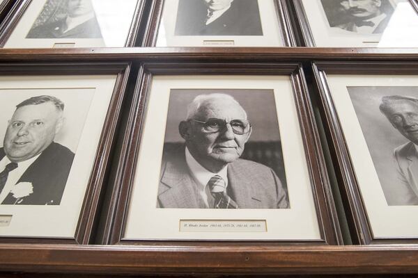 A photo of Mayor Judy Jordan Johnsons’s father, former Lawrenceville Mayor H. Rhodes Jordan (center), is displayed along other images of former mayors in a hallway at Lawrenceville City Hall. Mayor Judy Jordan Johnson will be the first woman to have a photograph on the wall. (ALYSSA POINTER/ALYSSA.POINTER@AJC.COM)