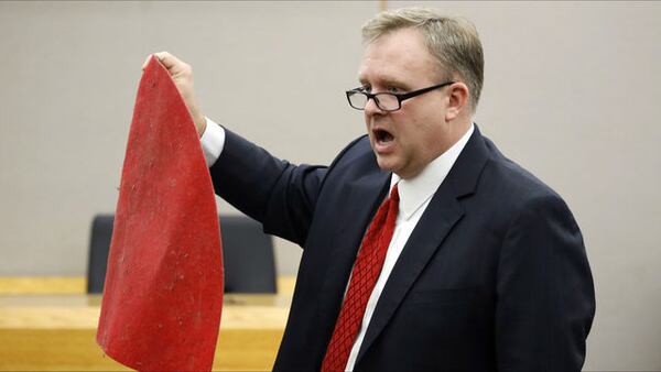 Prosecutor Jason Hermus shows jurors Botham Jean's red doormat Sept. 30, 2019, during closing arguments in the murder trial of ex-Dallas police officer Amber Guyger. Guyger, 31, was convicted of killing Jean, her neighbor, on Sept. 6, 2018.