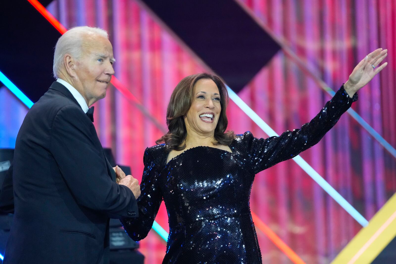 President Joe Biden, left, with Democratic presidential nominee Vice President Kamala Harris, right, on stage at the Congressional Black Caucus Foundation's Phoenix Awards Dinner in Washington, Saturday, Sept. 14, 2024. (AP Photo/Mark Schiefelbein)