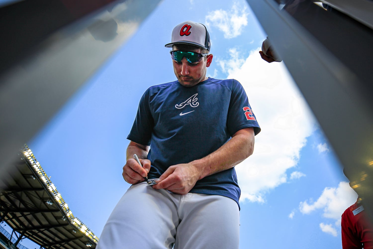 Atlanta Braves player Austin Riley signs an autograph before the game against the Tampa Bay Rays at Truist Park in Atlanta, Georgia  on Friday, June 14, 2024.   (Ziyu Julian Zhu / AJC)