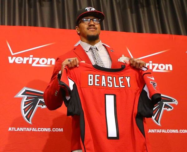 FILE PHOTO: Falcons general manager Thomas Dimitroff and head coach Dan Quinn introduce their first-round draft pick Vic Beasley at the Falcons training facility where he will hold a press conference with the team on Friday, May 1, 2015, in Flowery Branch. Beasley, who was the 8th overall pick in the NFL draft, is Clemson's all time sack leader. (Curtis Compton / ccompton@ajc.com)