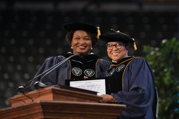 Former Spelman Board Chair and interim President Rosalind Brewer (right), presents Stacey Abrams (left) with the Community Service Award during Spelman's 2022 Spring Commencement. (Natrice Miller/AJC)