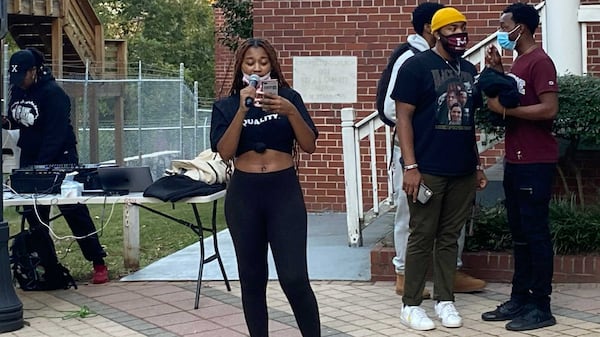 Clark Atlanta University senior Alivia Duncan reads a list of demands from Atlanta University Center students from their schools and federal officials for better housing and student loan debt relief during a demonstration on Oct. 18, 2021. (Eric Stirgus/eric.stirgus@ajc.com.)