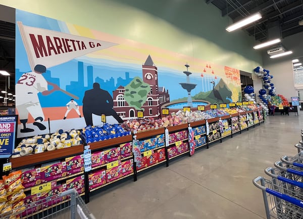 This mural inside the new Kroger store in Marietta depicts Cobb County imagery including the courthouse, the Marietta Square fountain, baseball players and the Atlanta skyline in the background, as seen on Thursday, August 3, 2023. (Taylor Croft/taylor.croft@ajc.com)