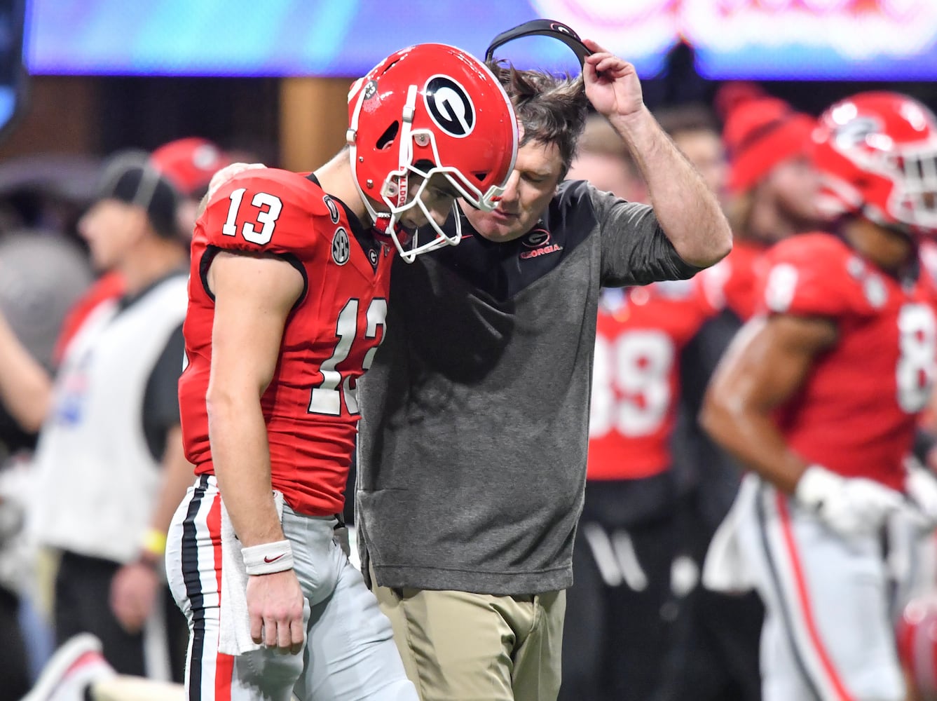 Georgia Bulldogs head coach Kirby Smart talks with quarterback Stetson Bennett (13) at the end of the first half during the College Football Playoff Semifinal between the Georgia Bulldogs and the Ohio State Buckeyes at the Chick-fil-A Peach Bowl In Atlanta on Saturday, Dec. 31, 2022. (Hyosub Shin / Hyosub.Shin@ajc.com)