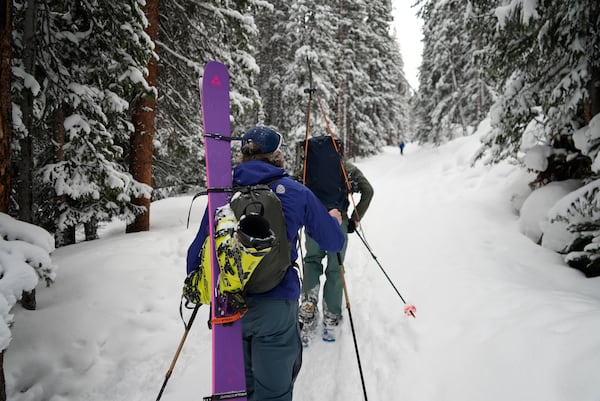 Michael Otenbaker and Joseph Burgoyne snowshoe into a backcountry ski area Wednesday, March 5, 2025, in Frisco, Colo. (AP Photo/Brittany Peterson)