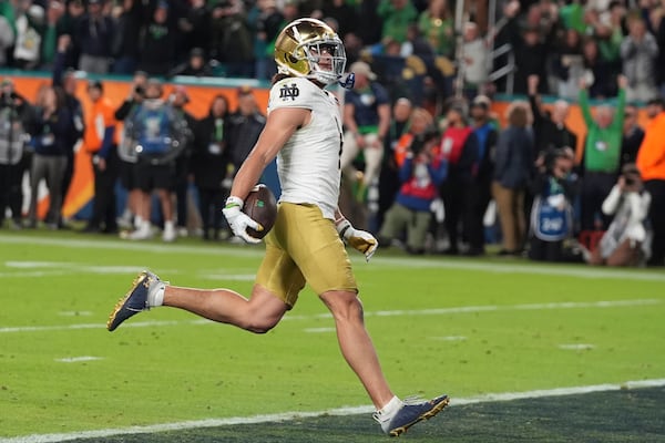 Notre Dame wide receiver Jaden Greathouse (1) scores a touchdown during the second half of the Orange Bowl College Football Playoff semifinal game against Penn State, Thursday, Jan. 9, 2025, in Miami Gardens, Fla. (AP Photo/Lynne Sladky)