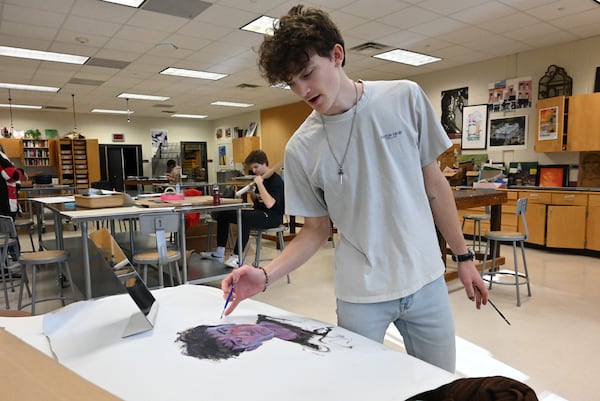 Senior Michael Peele paints a self-portrait at Lambert High School on Thursday, Dec. 12, 2024, in Suwanee. He hopes to study art at the University of Georgia. (Hyosub Shin/AJC)