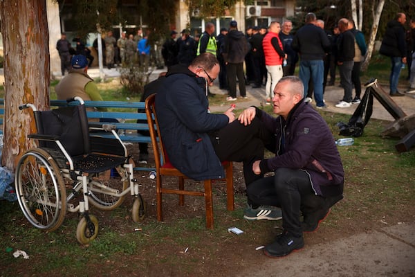 People wait outside a hospital in the town of Kocani, North Macedonia, Sunday, March 16, 2025, following a massive fire in a nightclub early Sunday. (AP Photo/Armin Durgut)