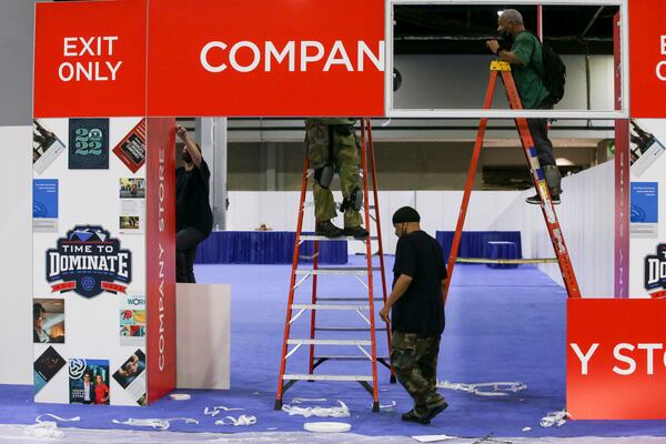 Workers prepare a hall in the Georgia World Congress Center on Tuesday, June 28, 2022, for a Primerica convention that will begin on Wednesday in both the center and Mercedes-Benz Stadium in Atlanta. Primerica, a Duluth-based financial services company, expects 35,000 attendees from across North America for its biennial convention. (Chris Day/Christopher.Day@ajc.com)