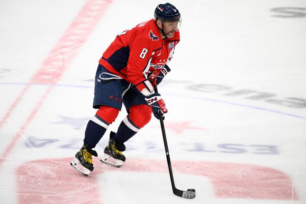 Washington Capitals left wing Alex Ovechkin (8) skates with the puck during the third period of an NHL hockey game against the Tampa Bay Lightning, Saturday, March 1, 2025, in Washington. (AP Photo/Nick Wass)