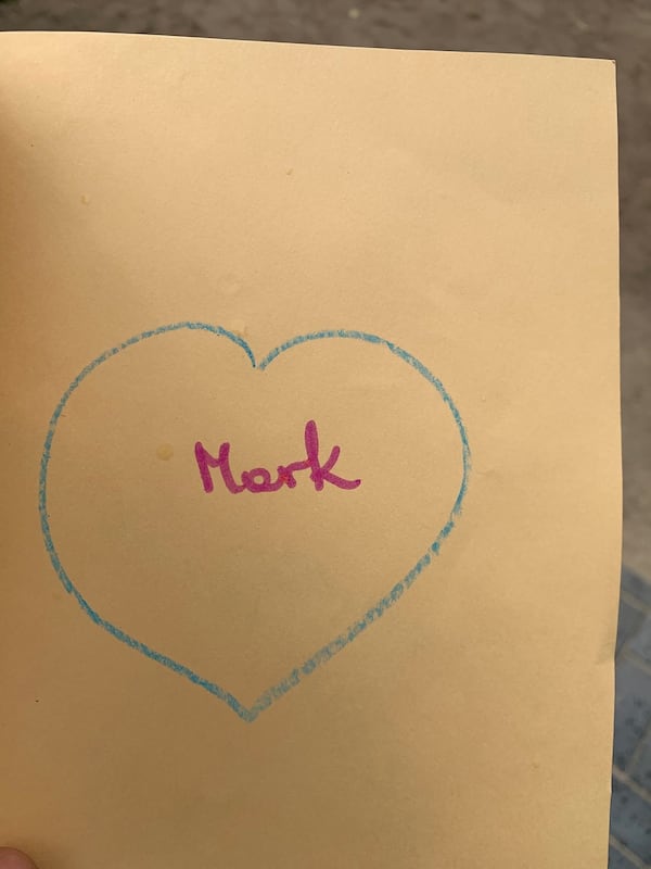 Veronika Kawka, 8, presented each of the Habitat for Humanity volunteers with a handmade card. On the front, she sketched a picture of her new house; inside, she wrote each of the volunteers’ names and drew a picture of a heart. MARK A. WALIGORE / MARK.WALIGORE@AJC.COM