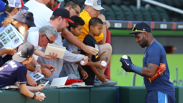 Braves outfielder Marcell Ozuna, who agreed to a 1-year, $18 million contract this offseason, signs autographs for fans after taking batting practice Sunday, Feb. 16, 2020, at CoolToday Park after arriving for spring training in North Port, Fla.