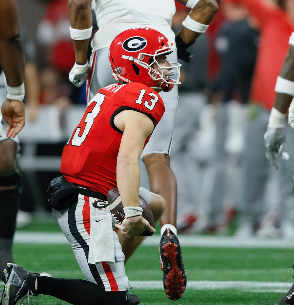 Georgia Bulldogs quarterback Stetson Bennett (13) is sacked for a loss during the third quarter of the College Football Playoff Semifinal between the Georgia Bulldogs and the Ohio State Buckeyes at the Chick-fil-A Peach Bowl In Atlanta on Saturday, Dec. 31, 2022. (Jason Getz / Jason.Getz@ajc.com)