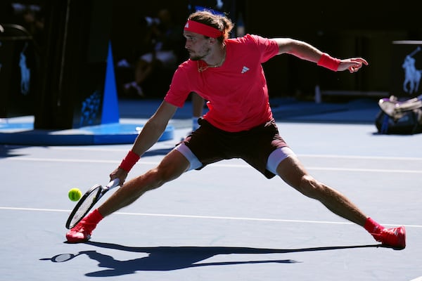 Alexander Zverev of Germany plays a backhand return to Tommy Paul of the U.S. during their quarterfinal match at the Australian Open tennis championship in Melbourne, Australia, Tuesday, Jan. 21, 2025. (AP Photo/Vincent Thian)