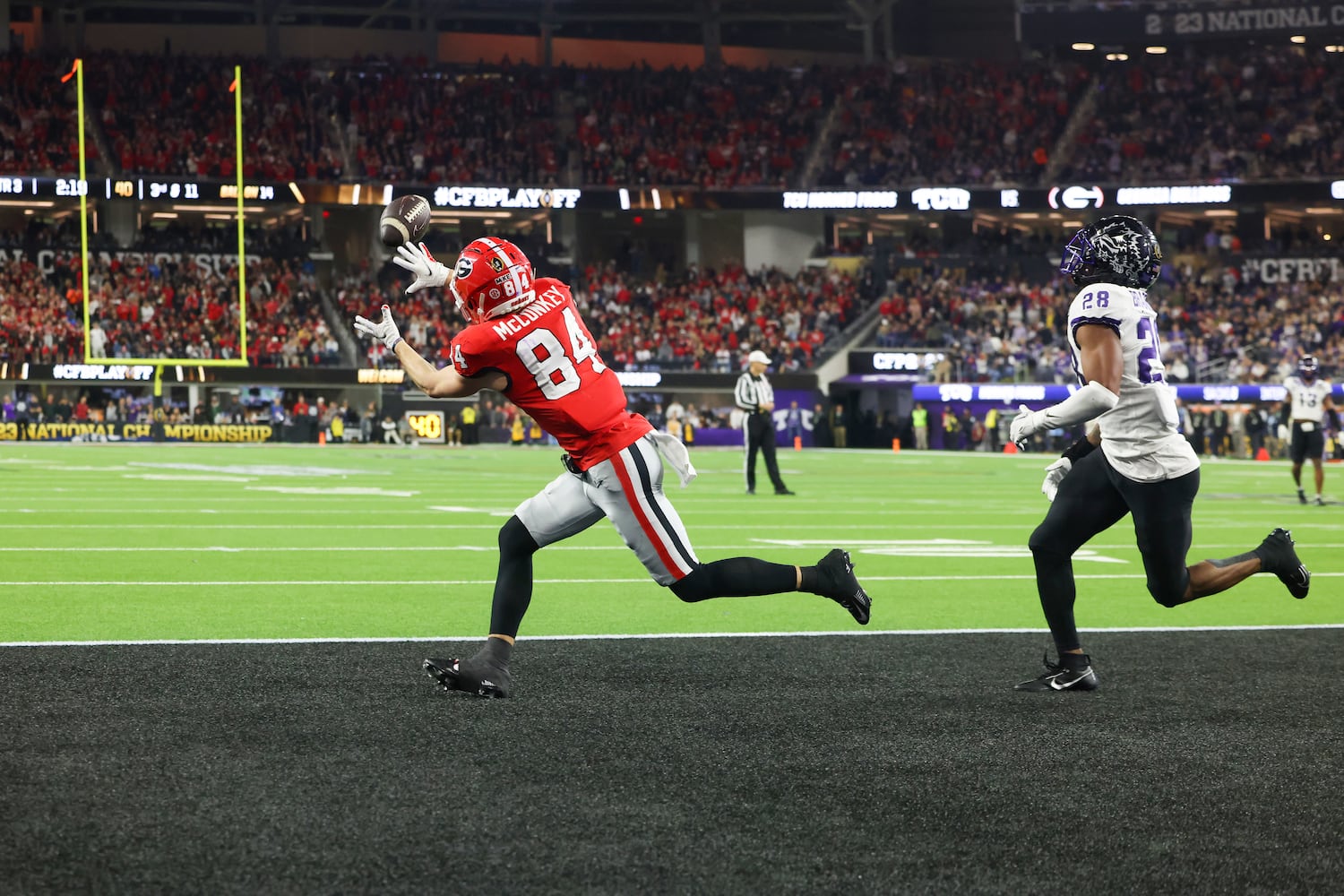 Georgia Bulldogs wide receiver Ladd McConkey (84) catches a touchdown pass against TCU Horned Frogs safety Millard Bradford (28) during the second half of the College Football Playoff National Championship at SoFi Stadium in Los Angeles on Monday, January 9, 2023. Georgia won 65-7 and secured a back-to-back championship. (Jason Getz / Jason.Getz@ajc.com)