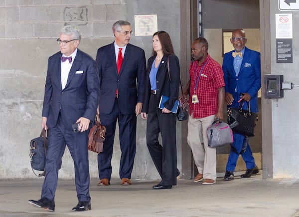 Georgia Secretary of State Brad Raffensperger (second from left) leaves Federal Court in Atlanta after testifying on Monday, Aug. 28, 2023.  (Miguel Martinez / Miguel.Martinezjimenez@ajc.com)