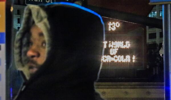 Dominique Patterson waited for a bus to pick him up on Peachtree Street in downtown Atlanta on a cold night in January. JOHN SPINK/JSPINK@AJC.COM