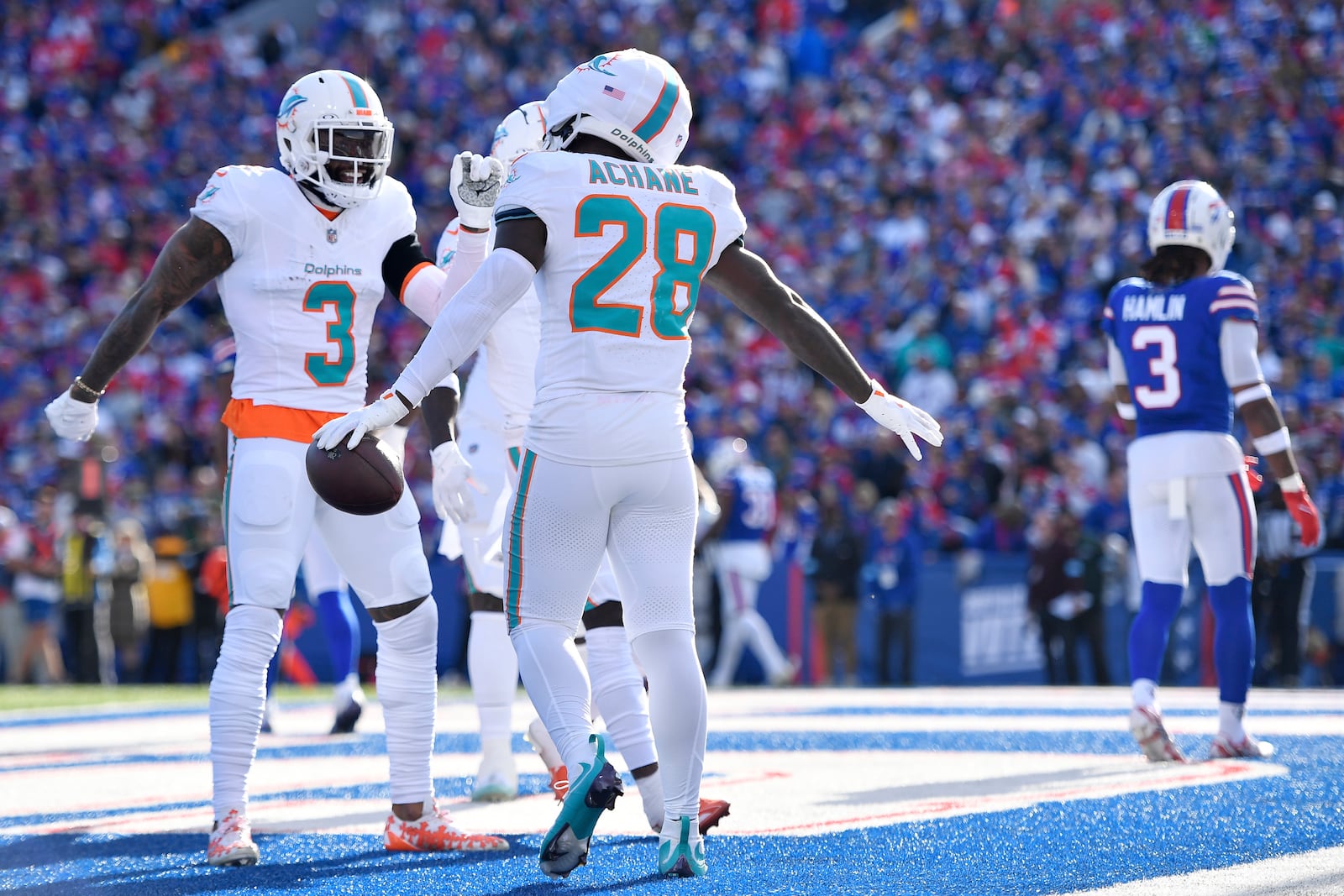 Miami Dolphins running back De'Von Achane (28) celebrates with wide receiver Odell Beckham Jr. (3) after scoring a touchdown during the first half of an NFL football game against the Buffalo Bills, Sunday, Nov. 3, 2024, in Orchard Park, N.Y. (AP Photo/Adrian Kraus)