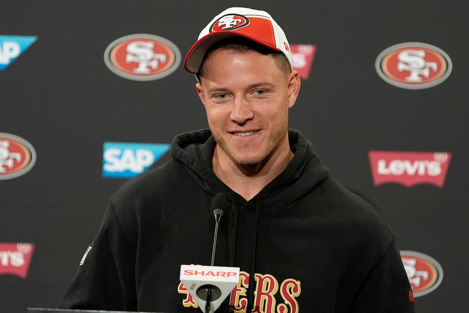 FILE - San Francisco 49ers running back Christian McCaffrey speaks with the media after NFL football practice in Santa Clara, Calif., Tuesday, June 4, 2024. (AP Photo/Tony Avelar, File)