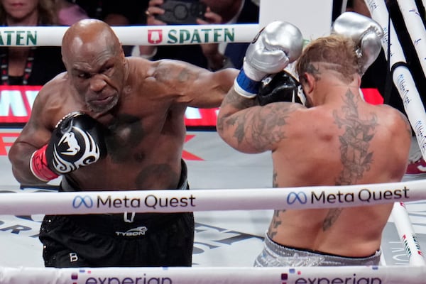 Mike Tyson lands a left to Jake Paul during their heavyweight boxing match, Friday, Nov. 15, 2024, in Arlington, Texas. (AP Photo/Julio Cortez)