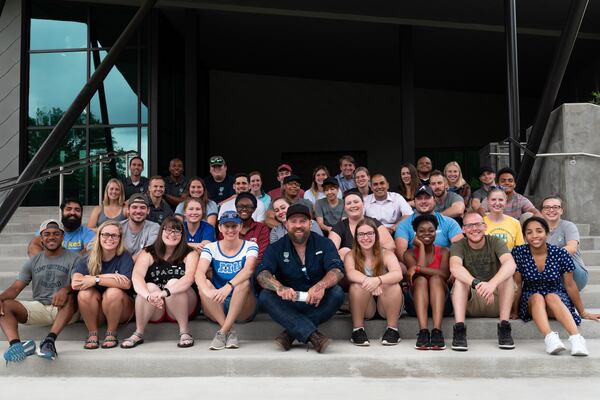 Zac Brown sits with counselors from Camp Southern Ground , a nonprofit organization he founded.