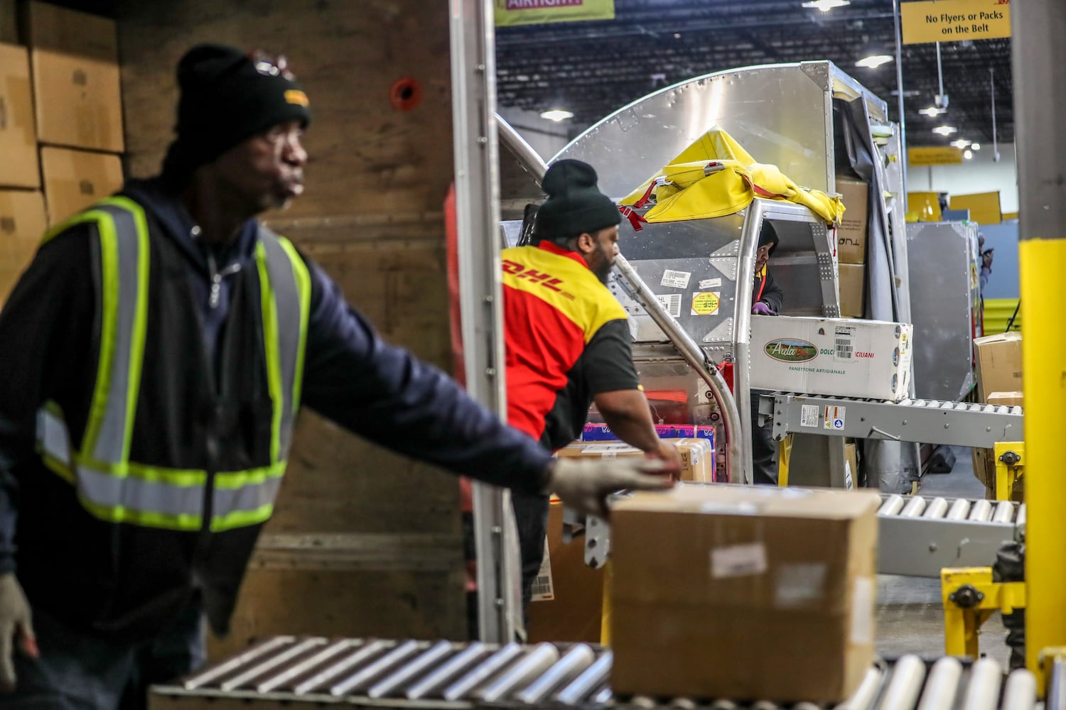 December 15, 2022 ATLANTA: Left to right - Tony Glass, Djuan Moore and Shawn Williams unload the big plane cartons for sorting.  (John Spink / John.Spink@ajc.com)

