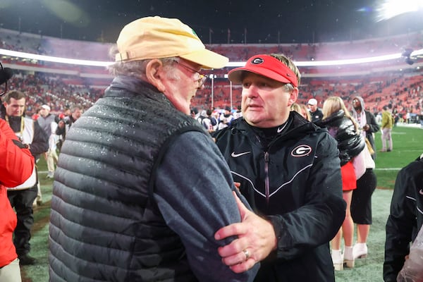 Georgia head coach Kirby Smart celebrates with his father, Sonny Smart, after a win against Mississippi at Sanford Stadium, Saturday, November 11, 2023, in Athens, Ga. (Jason Getz / Jason.Getz@ajc.com)