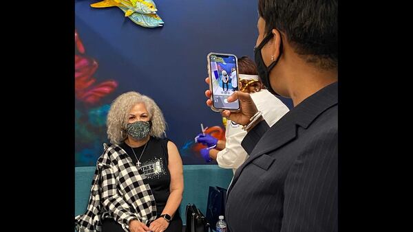 ATLANTA - Atlanta Mayor Keisha Lance Bottoms takes a photo of her mother, Sylvia Robinson, as she gets a Moderna COVID-19 vaccine shot at Morehouse School of Medicine on Jan. 5, 2021. ERIC STIRGUS/ESTIRGUS@AJC.COM.